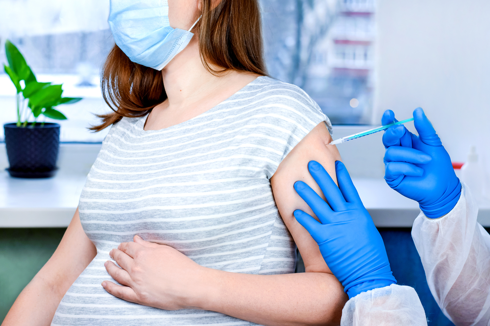 Pregnant woman getting covid-19 vaccine.