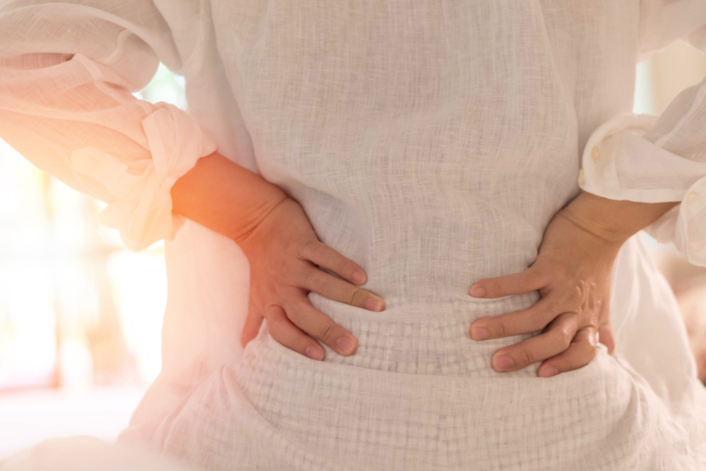 woman holding lower back